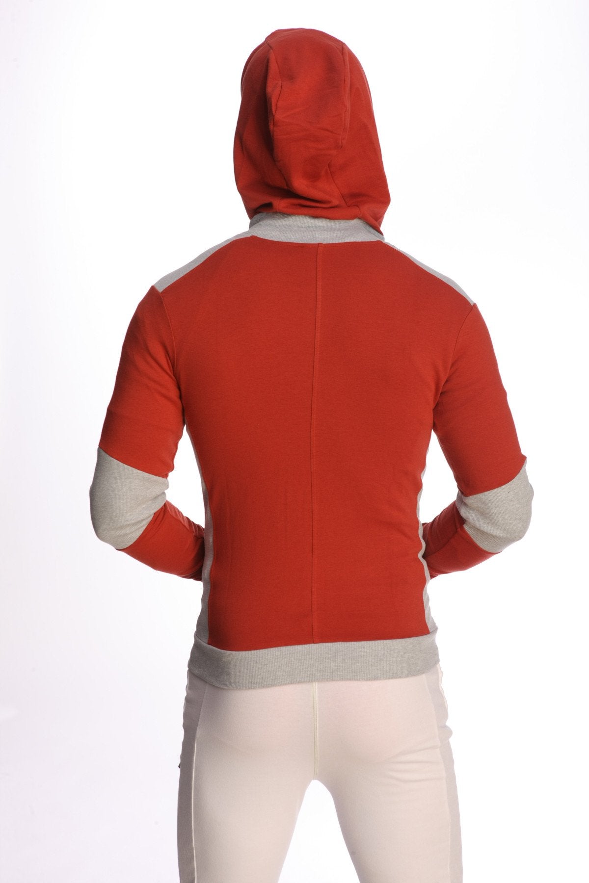 Form-fit crossover yoga track performance hoodie in cinnabar red with grey accents on shoulders sleeves and waistband