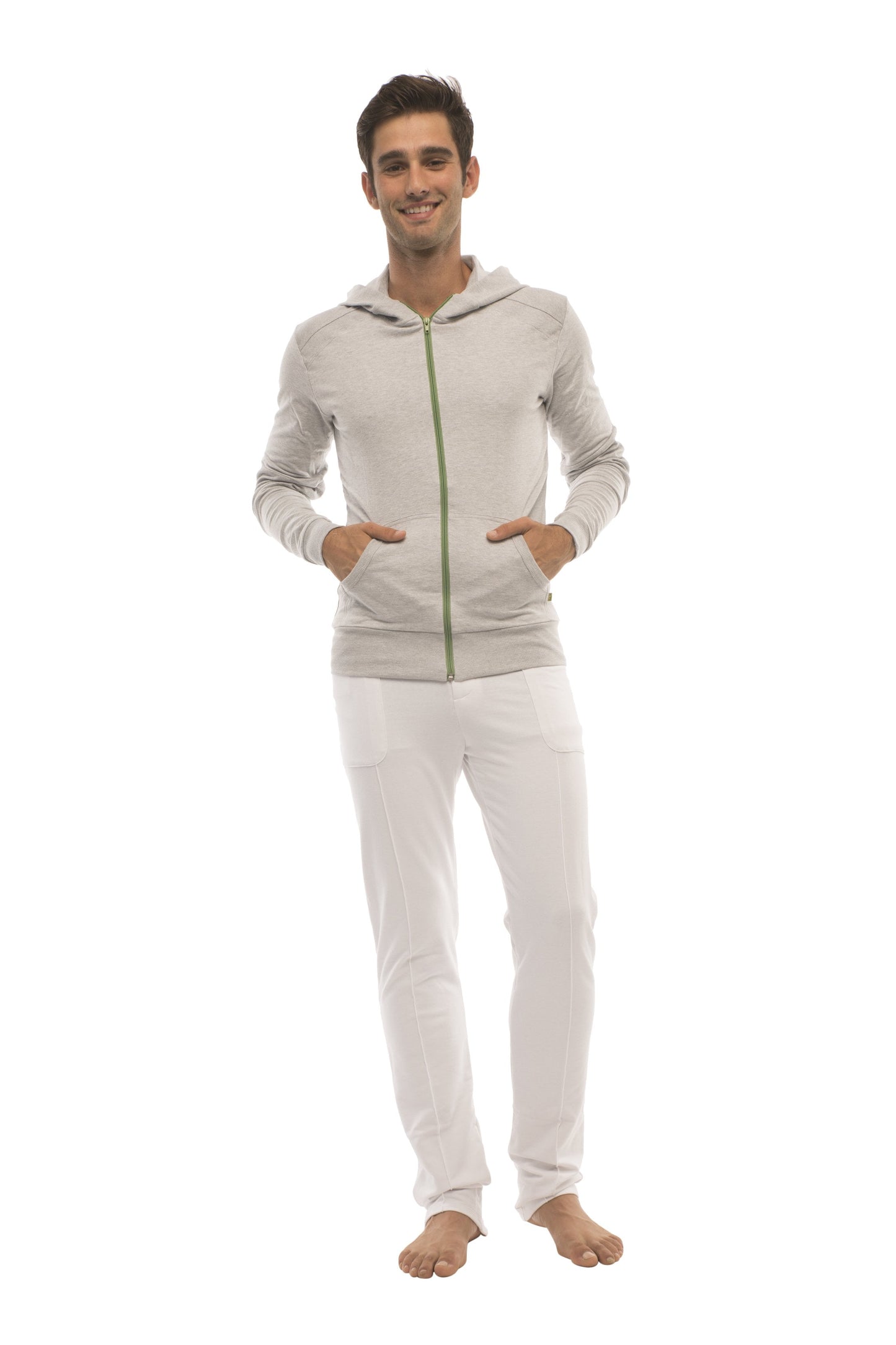 A light gray heather form-fit crossover yoga track performance hoodie with green zipper and hood worn by a model