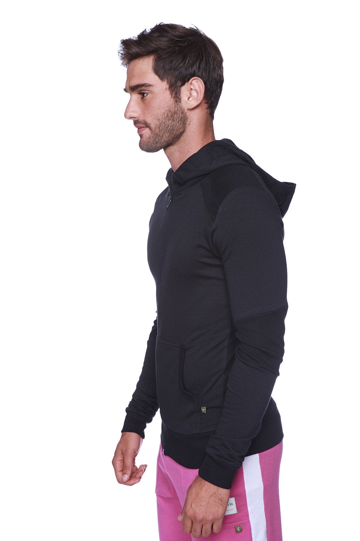 Form-fit crossover yoga track performance hoodie in solid black with subtle texture and black zipper paired with pink pants