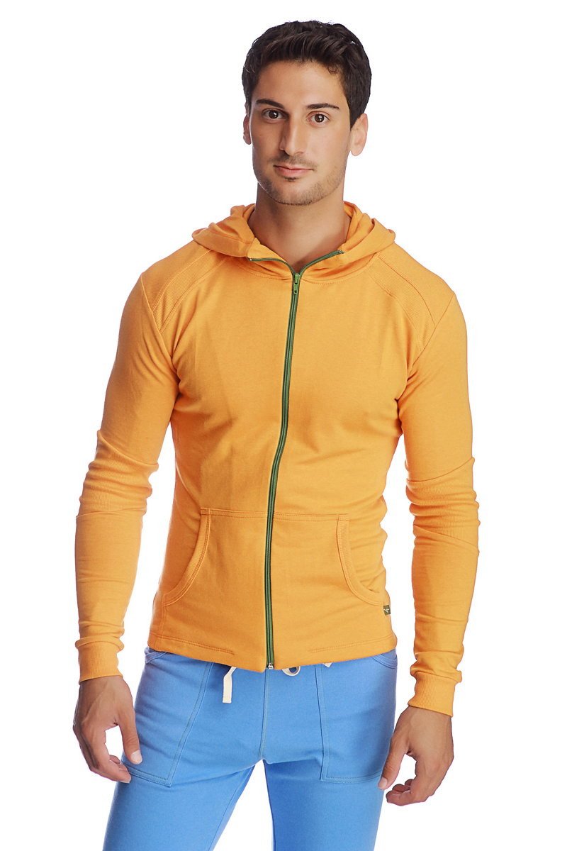 A vibrant sun orange form-fit crossover yoga track performance hoodie with green zipper and front pockets