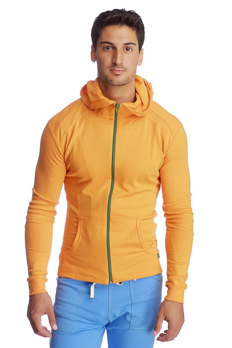 A form-fit crossover yoga track performance hoodie in sun orange with a green zipper and two front pockets