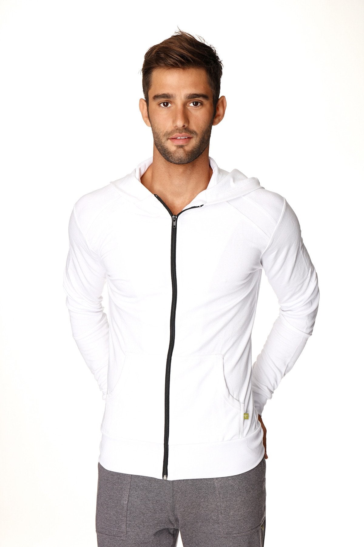 Form-fit crossover yoga track performance hoodie in white with black zipper and subtle side pockets for active wear