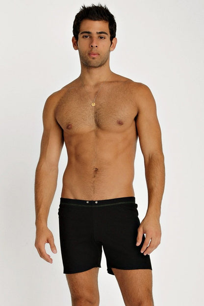 Black fusion yoga short swim trunks with sleek modern design and subtle stitching along the waistband