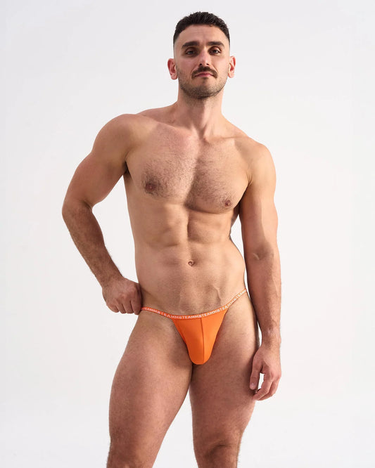 Bright orange glide micro brief thong with a thin matching elastic waistband made from smooth fabric