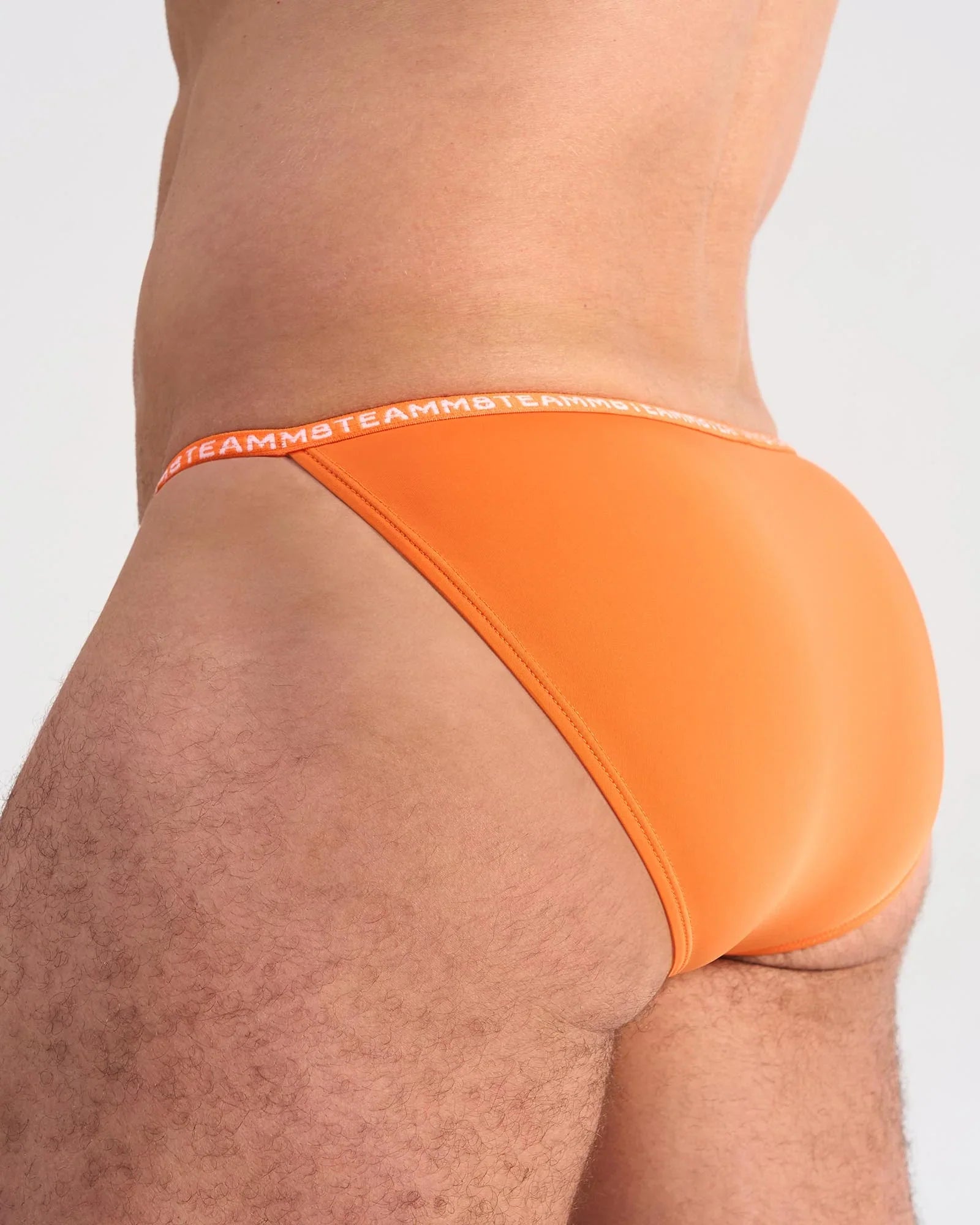 Bright orange glide micro brief with elastic waistband featuring the brand’s repeating logo for comfortable support