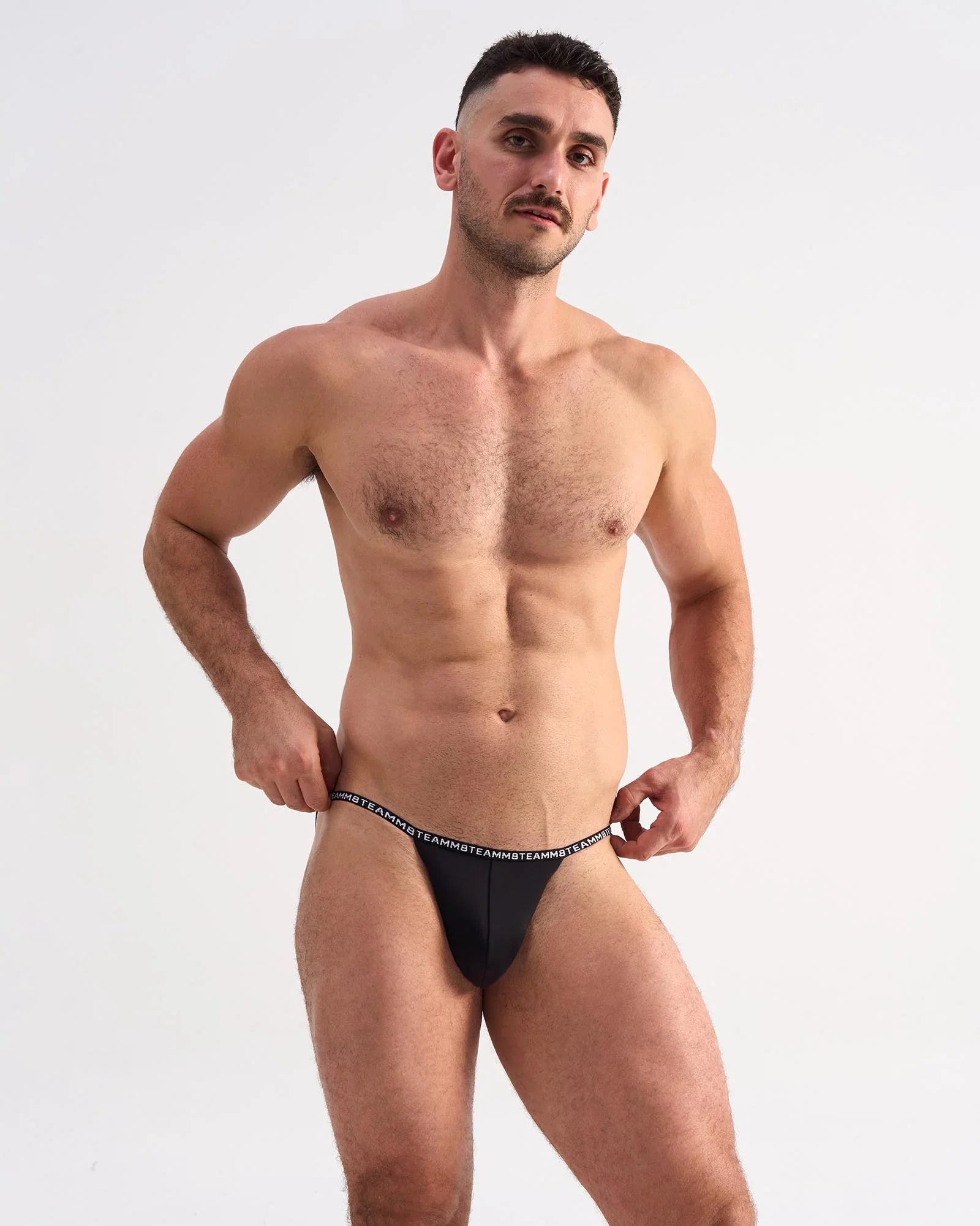 Black glide micro brief thong with white repeating text waistband showing back side design detail