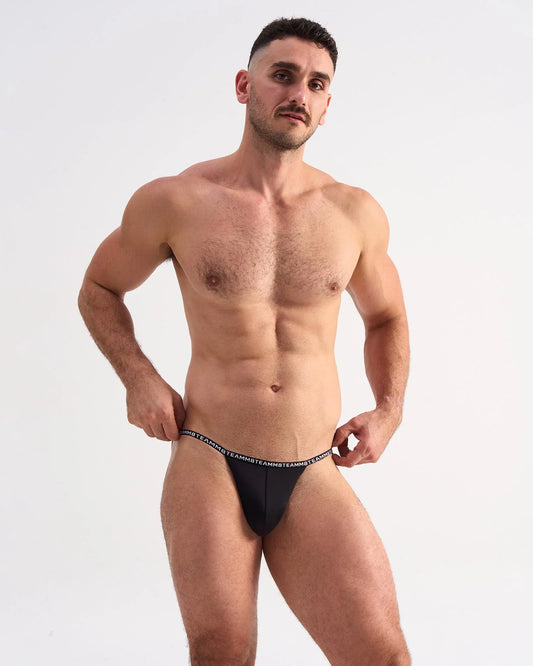 Black glide micro brief thong with white repeating text waistband showing back side design detail