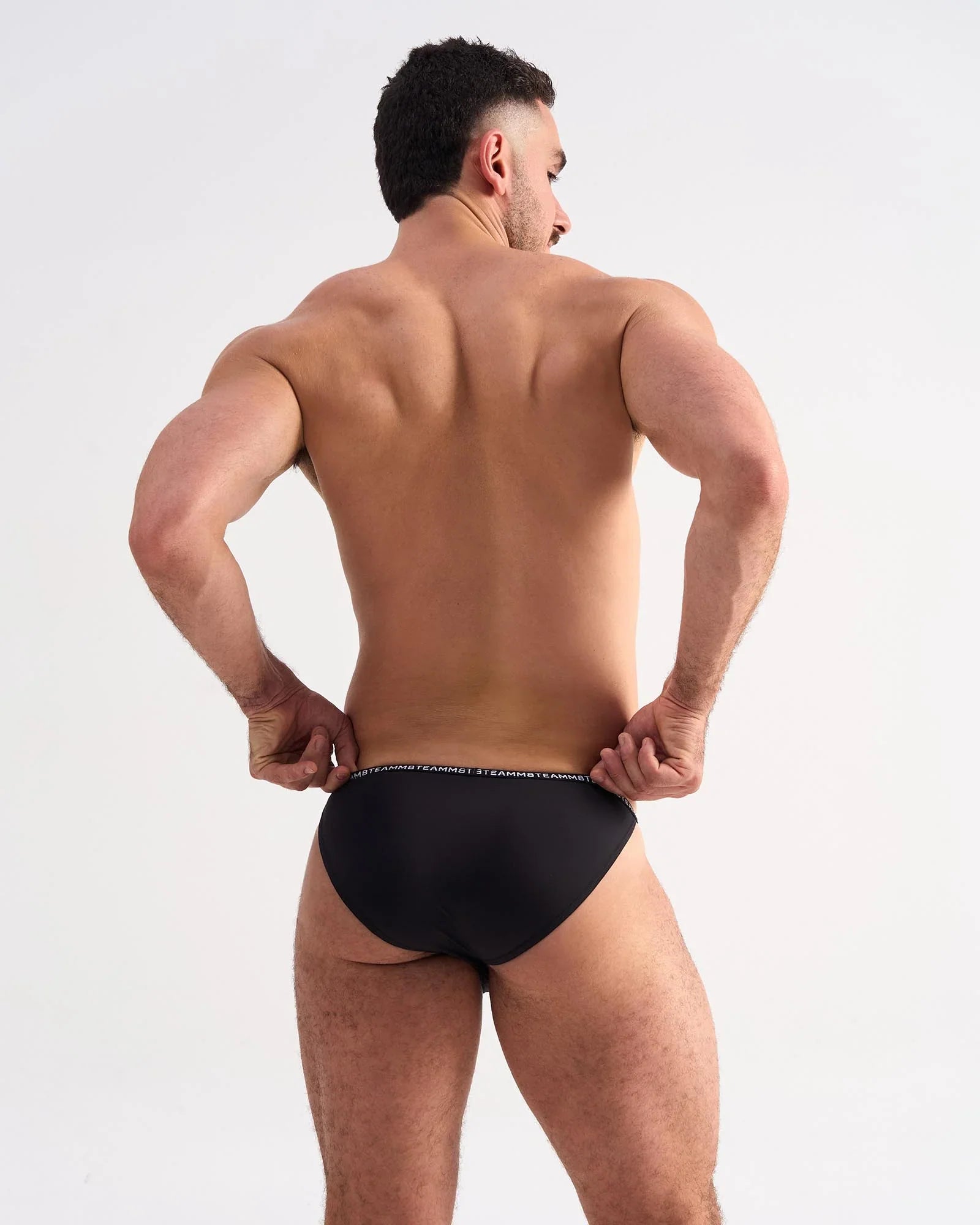 Black glide micro brief with subtle white logo trim on waistband in soft breathable fabric for everyday comfort
