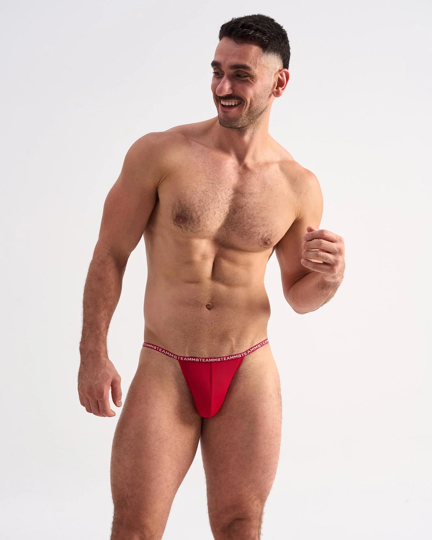 Red glide micro brief athletic briefs with thin elastic waistband featuring repeating white text design