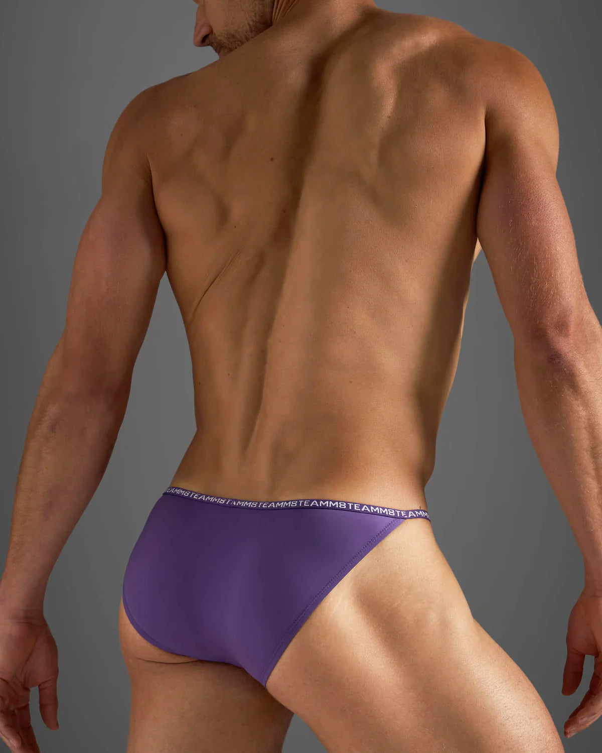 Purple glide micro brief athletic briefs with white repeating logo waistband band designed for active wear