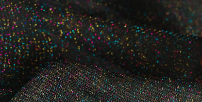 Black mesh glitter mesh tank fabric with sparkling multicolored glitter for stylish layering and fashion use