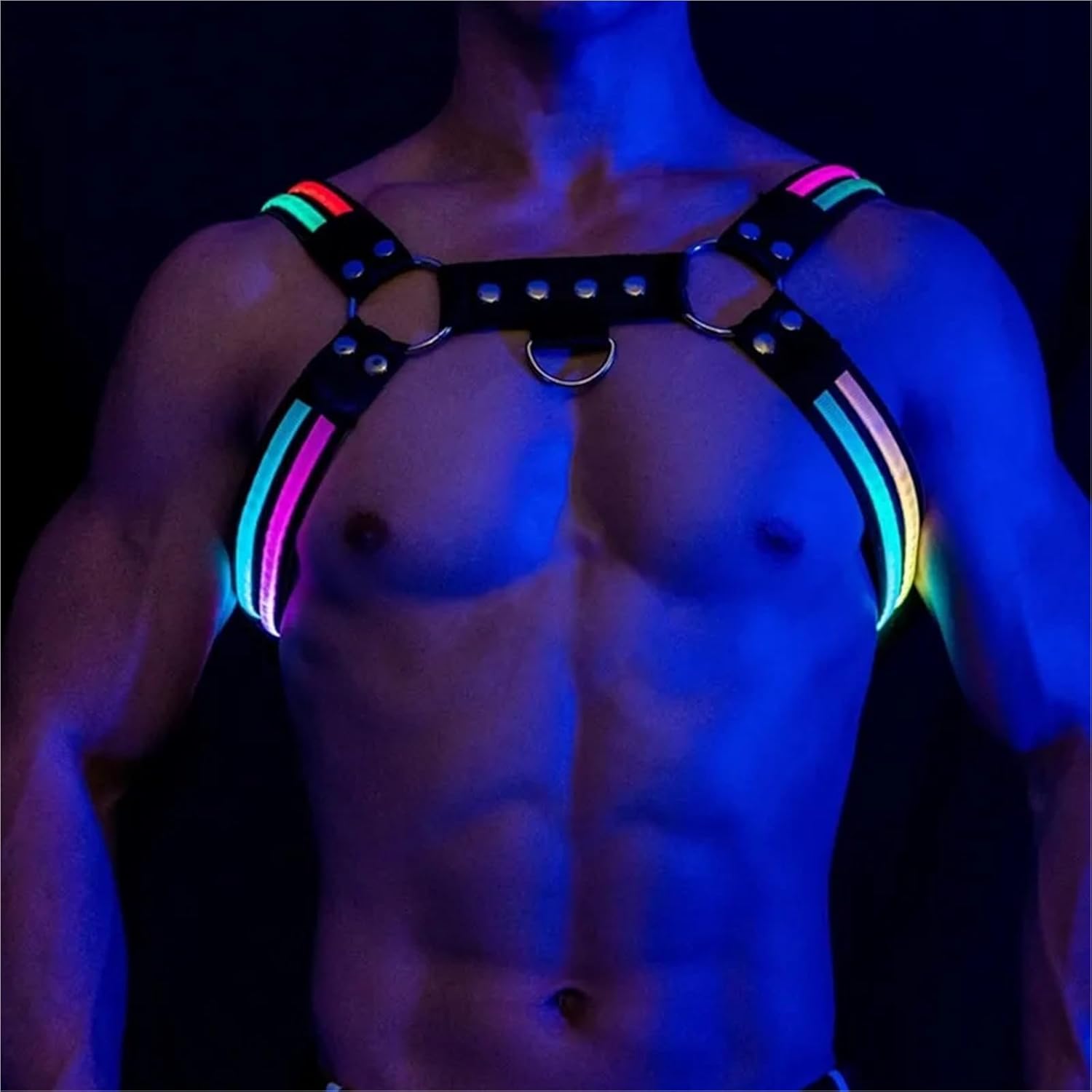Black leather harness with glowing pink and blue light strips, metal rings, and studs against a dark background.