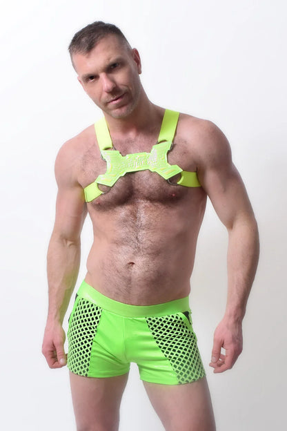 Bright neon green glowtime shorts mesh fabric paired with matching harness style top for bold activewear look
