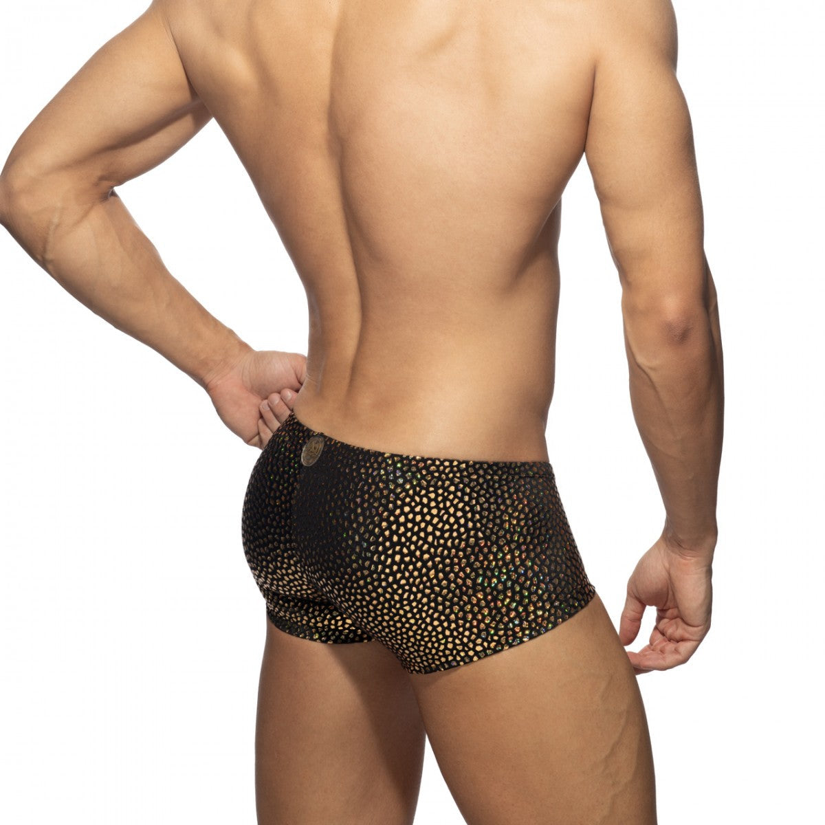 Black swim trunks with shimmering gold dot pattern from gold stones trunk collection for stylish beachwear