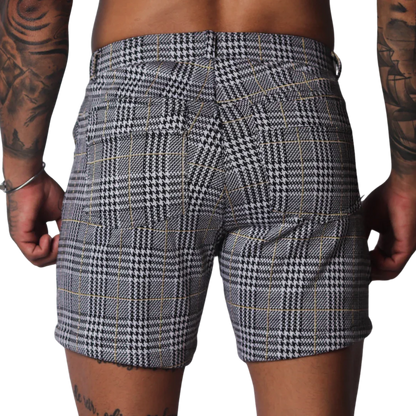 Black and white houndstooth print shorts with a subtle gold windowpane check pattern and two rear pockets.