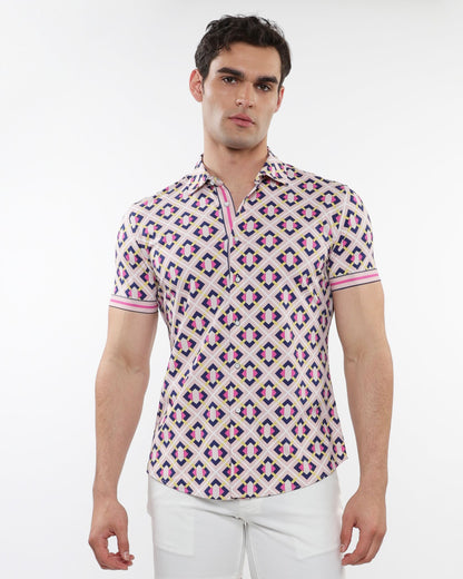A man wearing a grid parquet printed performance short-sleeved shirt with pink purple and beige geometric pattern