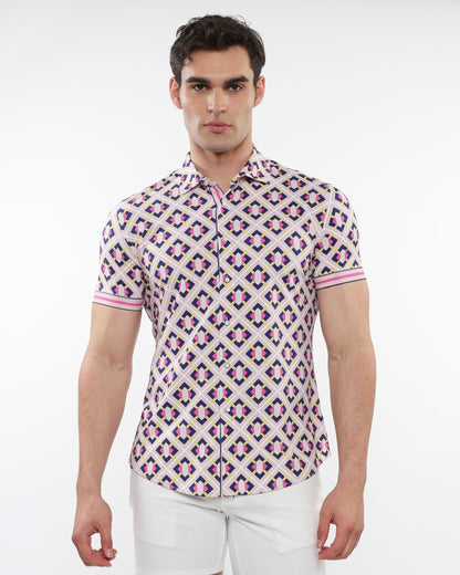 A man wearing a grid parquet printed performance short-sleeved shirt with pink purple and beige geometric pattern