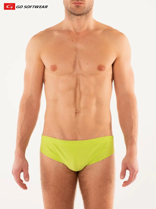 Lime green men's bikini swimwear by Go Softwear featuring a low-rise cut and a smooth finish modeled by a man with a toned physique