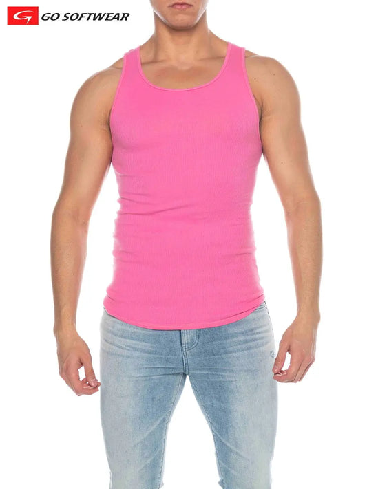 Model wearing a bright pink ribbed tank top by Go Softwear paired with light blue jeans showcasing a fitted style