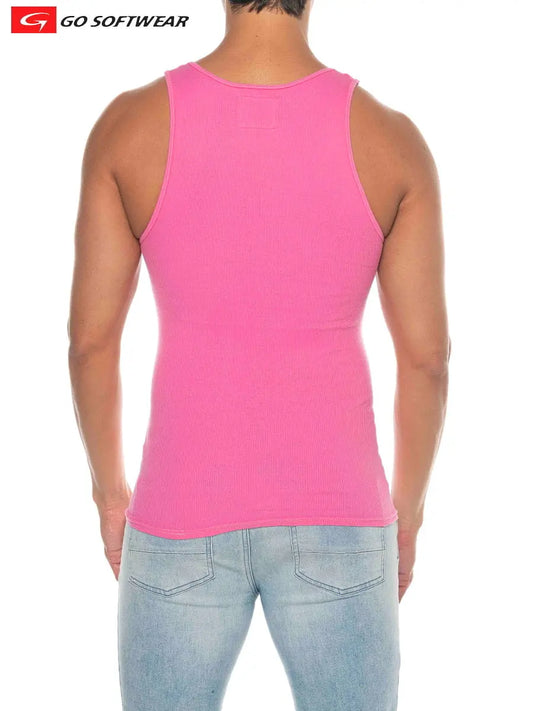 Model wearing a flamingo pink ribbed tank top from Go Softwear showing the back view with fitted design and light blue jeans