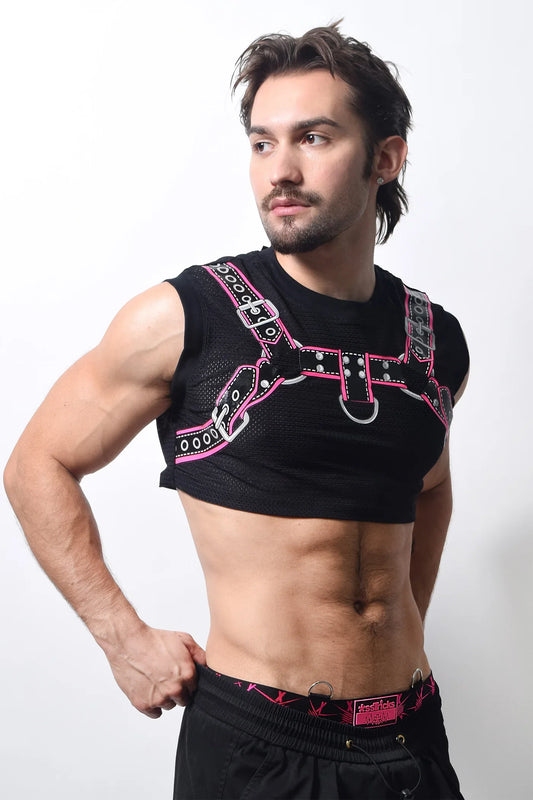 Harness crop top in black mesh with pink and silver leather-like straps and metal buckles and d-rings