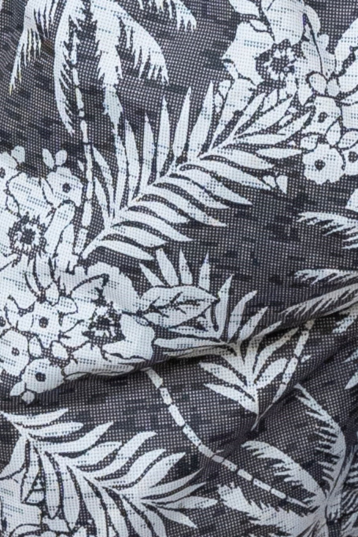 Black fabric hawaiian print swim short with white tropical palm trees flowers and leaves pattern