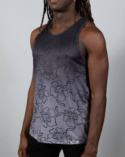 A dark gray hibiscus ombre print tank top with black outlined flowers fading to lighter gray at the bottom