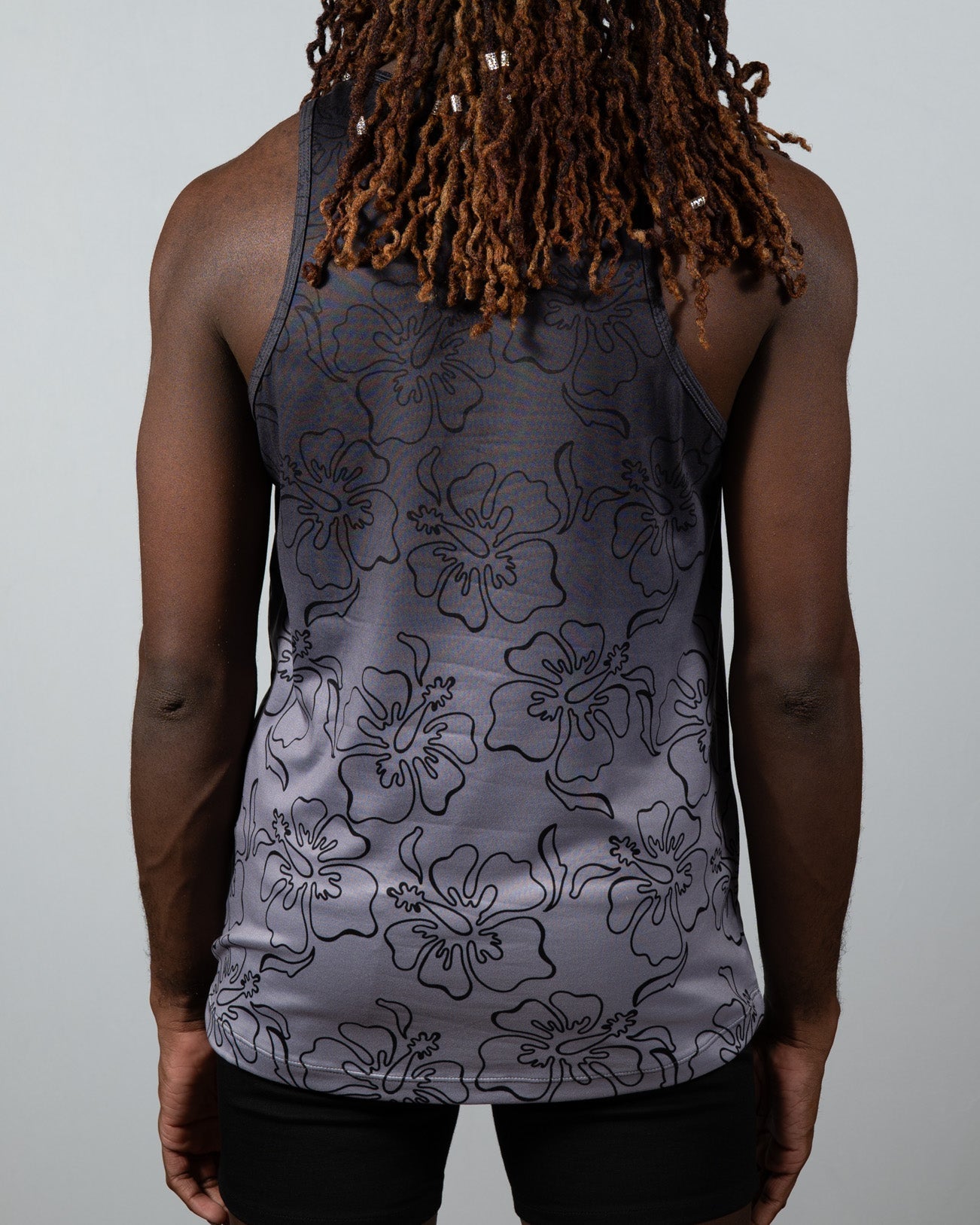 Gray hibiscus ombre print tank top with black outlined hibiscus flower pattern in a lightweight fabric
