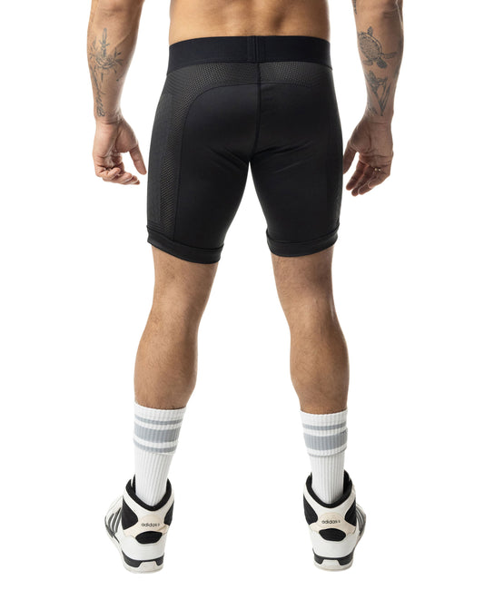 Rear view of black compression shorts featuring a wide waistband and textured mesh panels on sides.