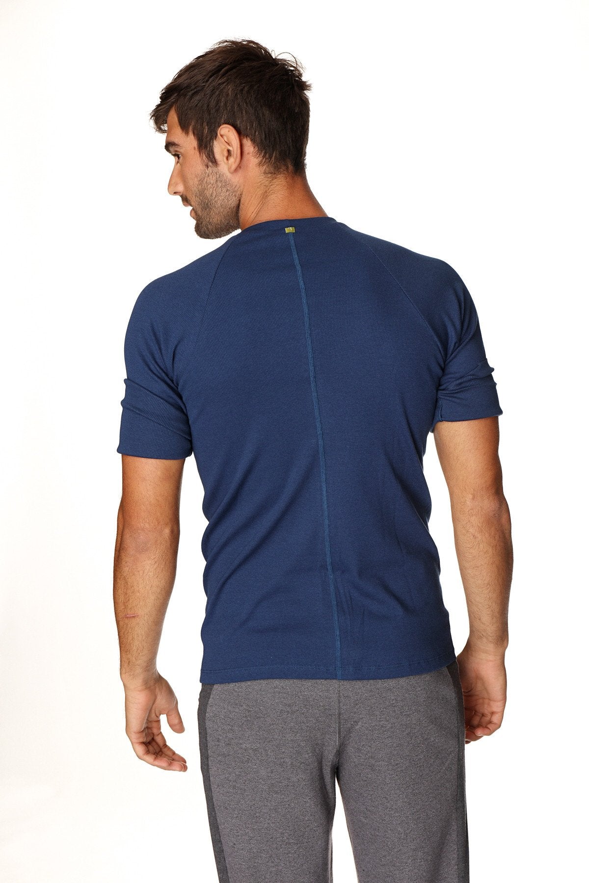 Navy blue short-sleeved hybrid crew neck raglan tee showing back with central seam designed for athletic use