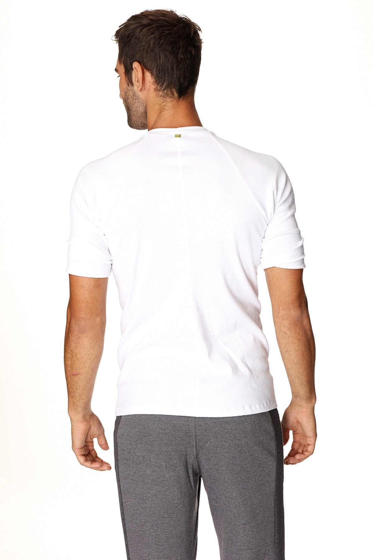White hybrid crew neck raglan tee with short sleeves and subtle ribbed detailing at the cuffs for athletic wear