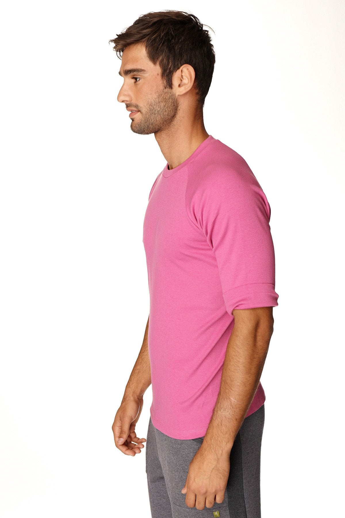A vibrant pink hybrid crew neck raglan tee with short sleeves and rolled cuffs designed for athletic wear