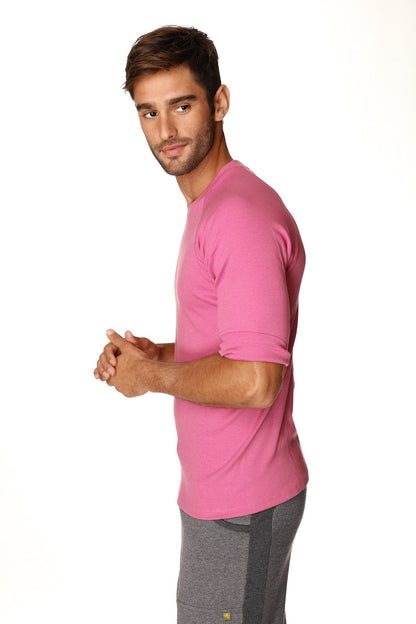 A man wearing a vibrant berry hybrid crew neck raglan tee with short sleeves and rolled-up cuffs