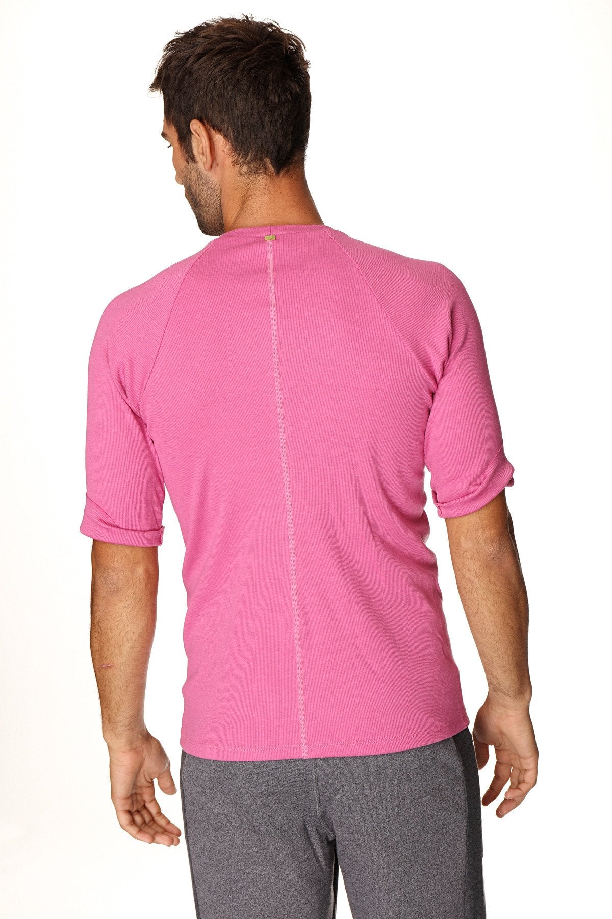A vibrant pink hybrid crew neck raglan tee with textured fabric and short sleeves for athletic wear