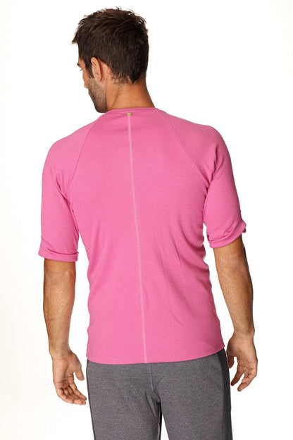 A vibrant pink hybrid crew neck raglan tee with textured fabric and short sleeves for athletic wear