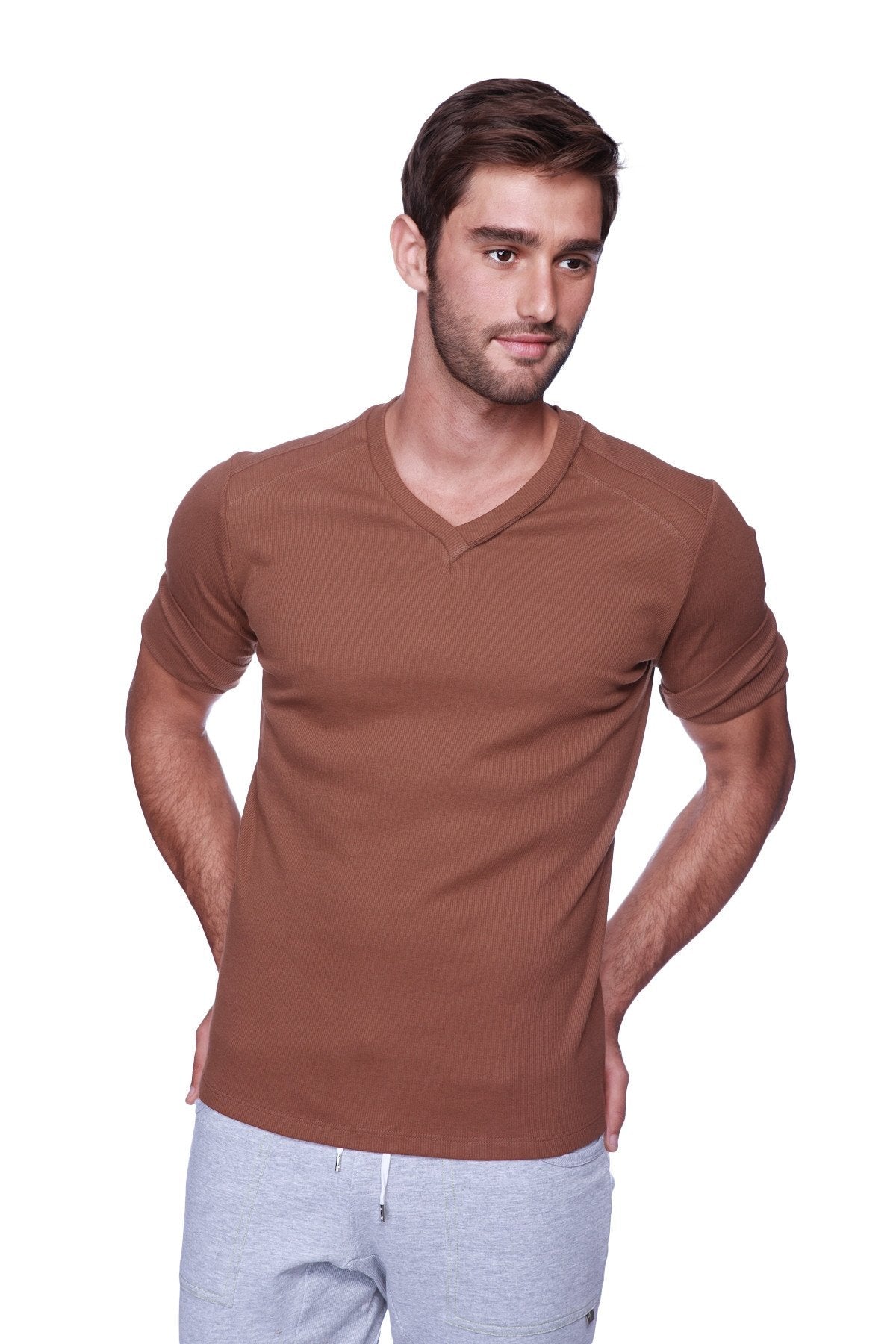 A man wearing a brown hybrid v-neck short-sleeved t-shirt made of soft fabric for casual wear
