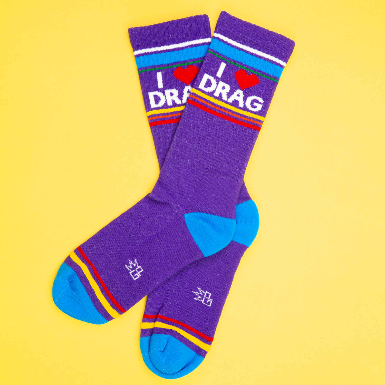 Purple crew socks with blue toes and heels featuring i heart drag lettering on the top cuff in white