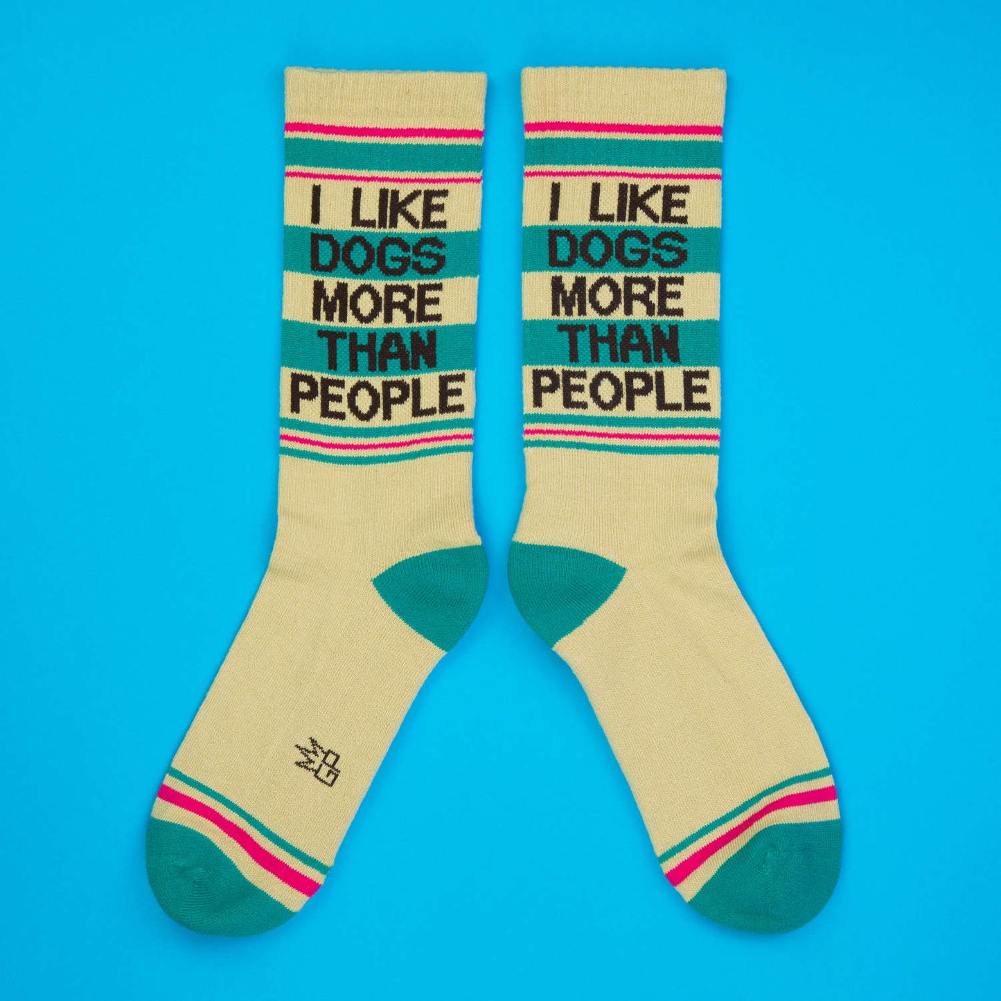 Cream-colored crew socks with teal and pink stripes featuring black text i like dogs more than people for casual wear