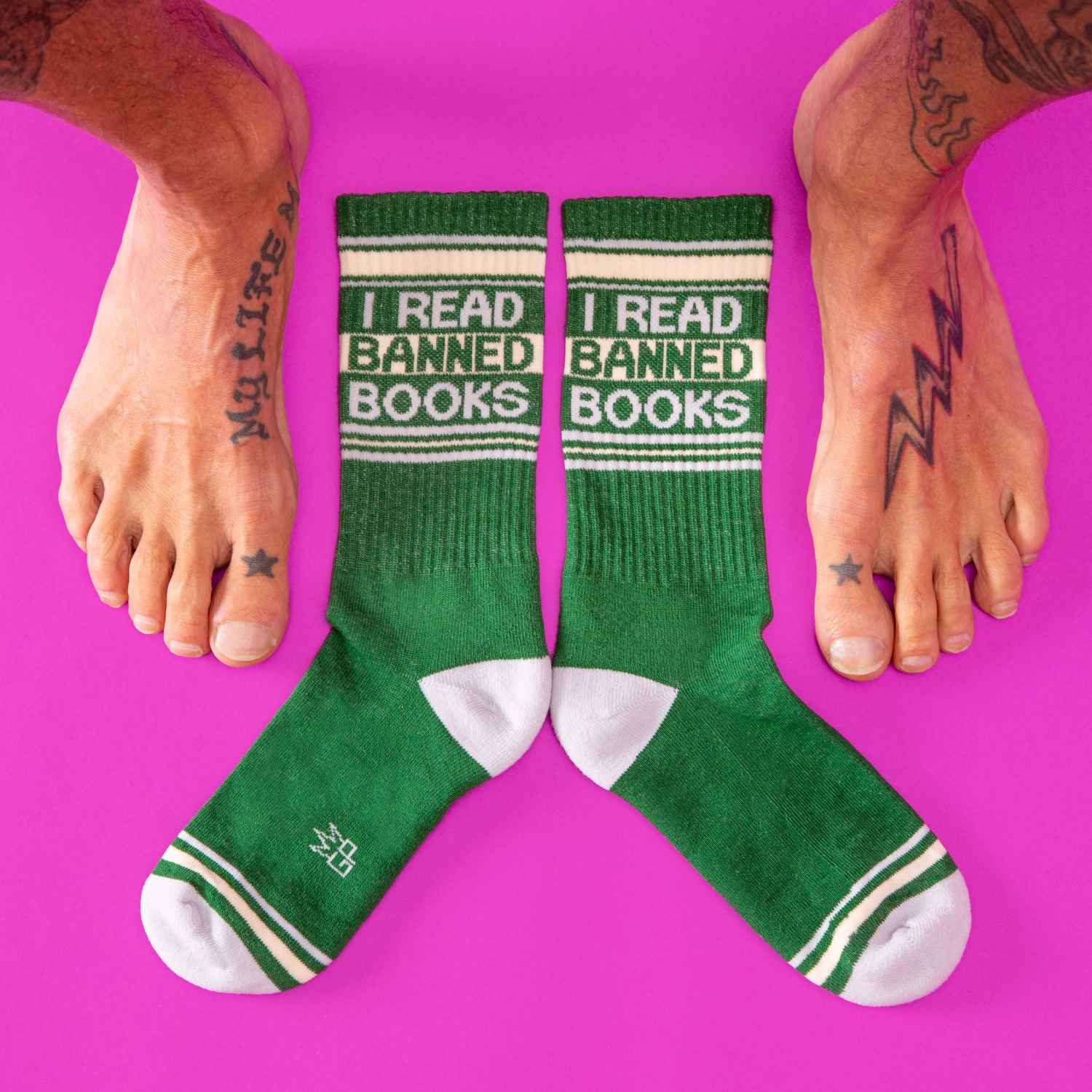 Green crew socks with white accents and bold black i read banned books text featuring ribbed texture and reinforced toes