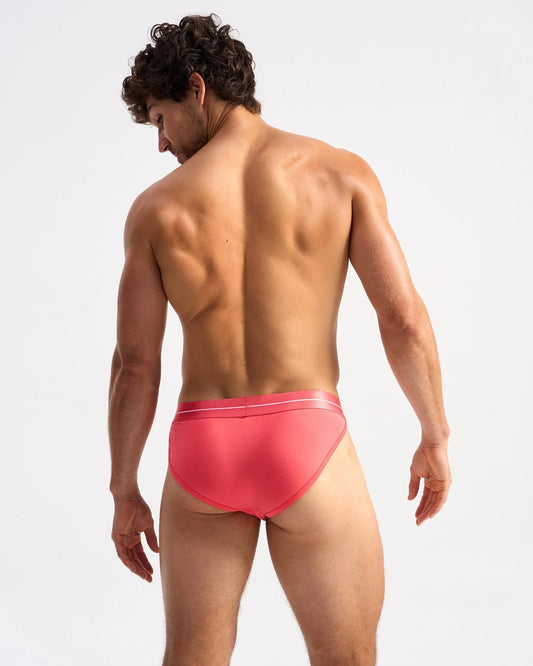 Icon sports brief in vibrant coral with sleek smooth fabric and subtle white trim along the waistband