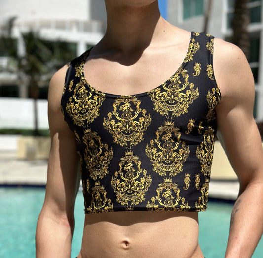 Men's black crop tank top with gold baroque pattern made of stretchy material shown by a model near a pool by Maris Equi