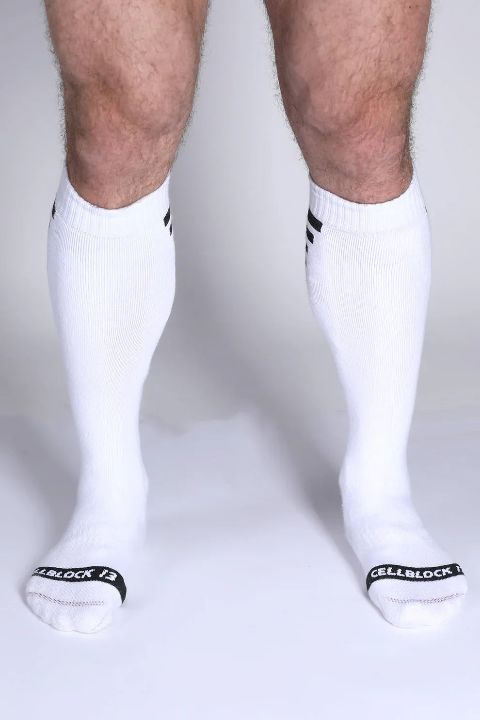 Iron Grip knee high socks in white with black striped cuffs and cellblock 13 branding on the toe