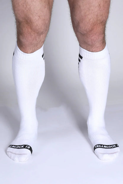 Iron Grip knee high socks in white with black striped cuffs and cellblock 13 branding on the toe