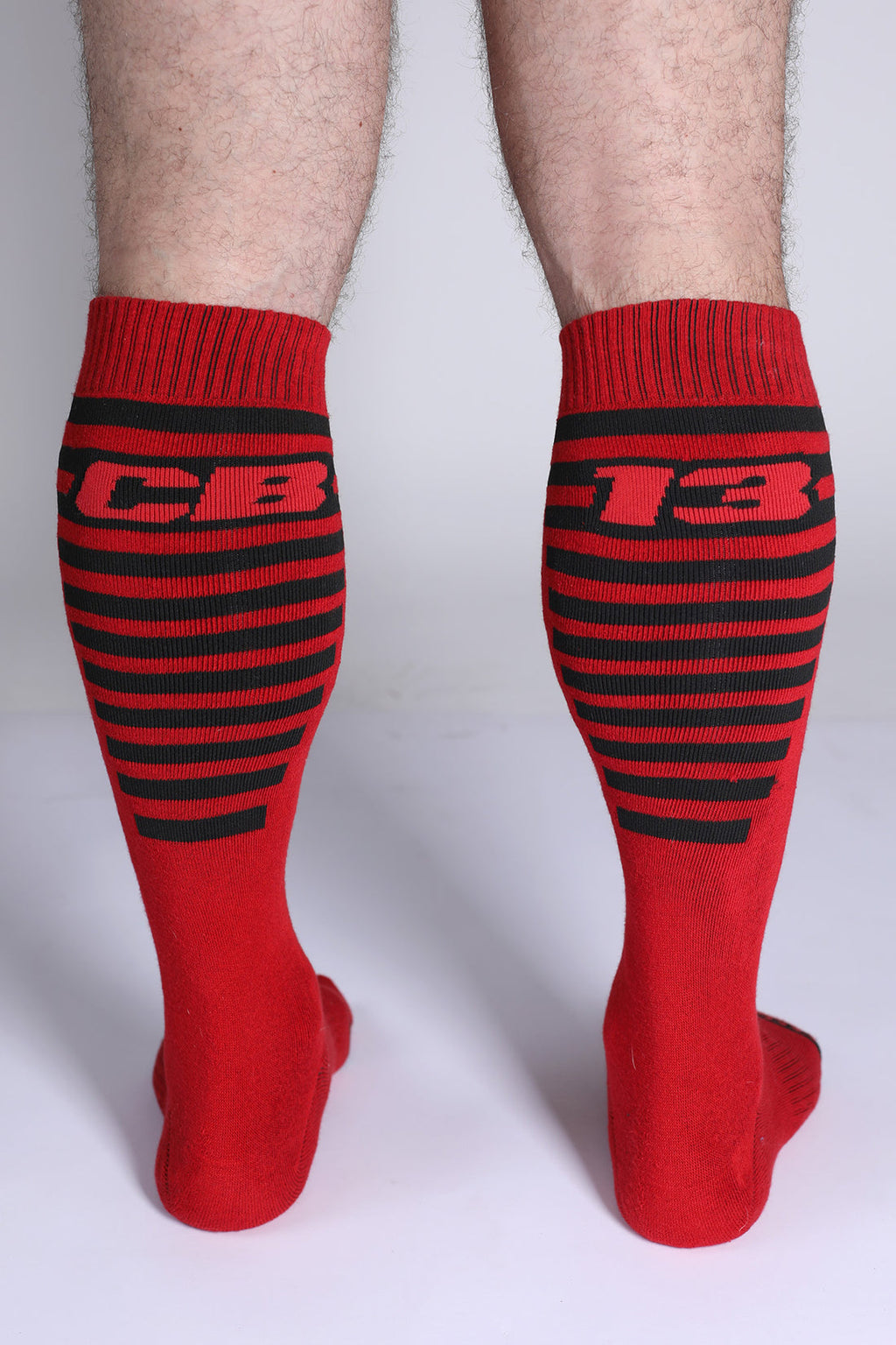 Iron Grip knee high socks in red with black stripes and bold cb 13 lettering on the upper leg