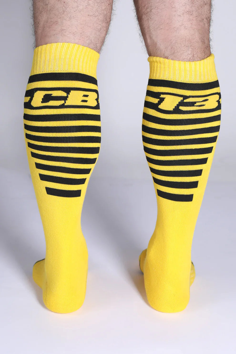 Iron grip knee high socks in bright yellow with bold black stripes and a cb-13 logo for athletic use