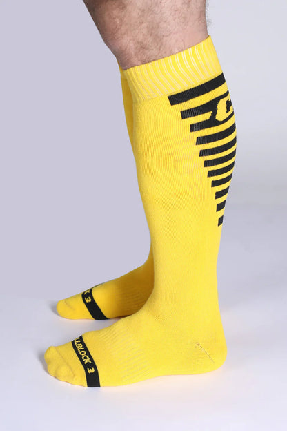 Iron grip knee high socks bright yellow with bold black stripes and reinforced toe caps for durability