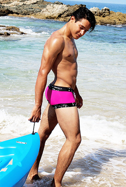 Icker Sea lace up contrast square cut swim trunks in bright fuchsia with black waistband and white polka dots