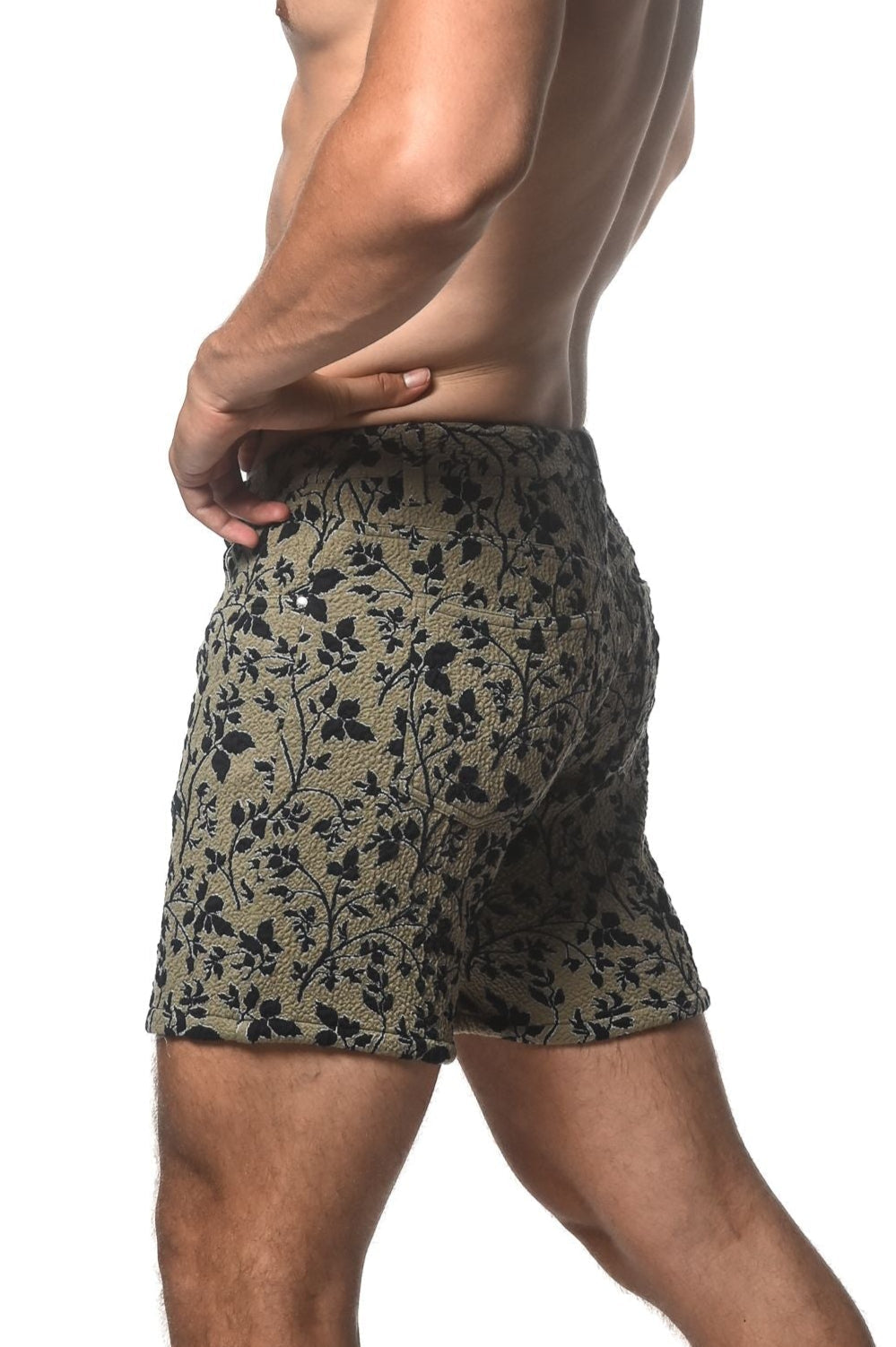 Olive green jacquard printed stretch knit shorts with black floral pattern and textured fabric