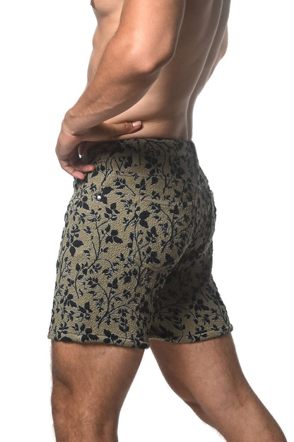 Olive green jacquard printed stretch knit shorts with black floral pattern and textured fabric
