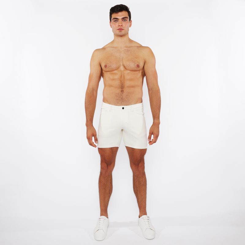 White jaquard stretch knit chino shorts with a sleek minimalist design and a black button at the waistband